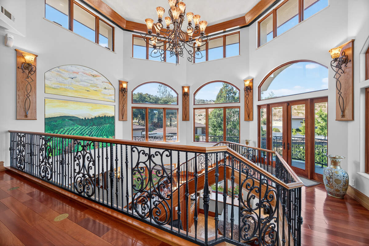 A view from the staircase shows the home’s more than 40-foot vertical center, along with cherrywood ceilings, Brazilian cherry floors, carved mahogany doors and the craftsmanship that shaped the multigenerational residence.
